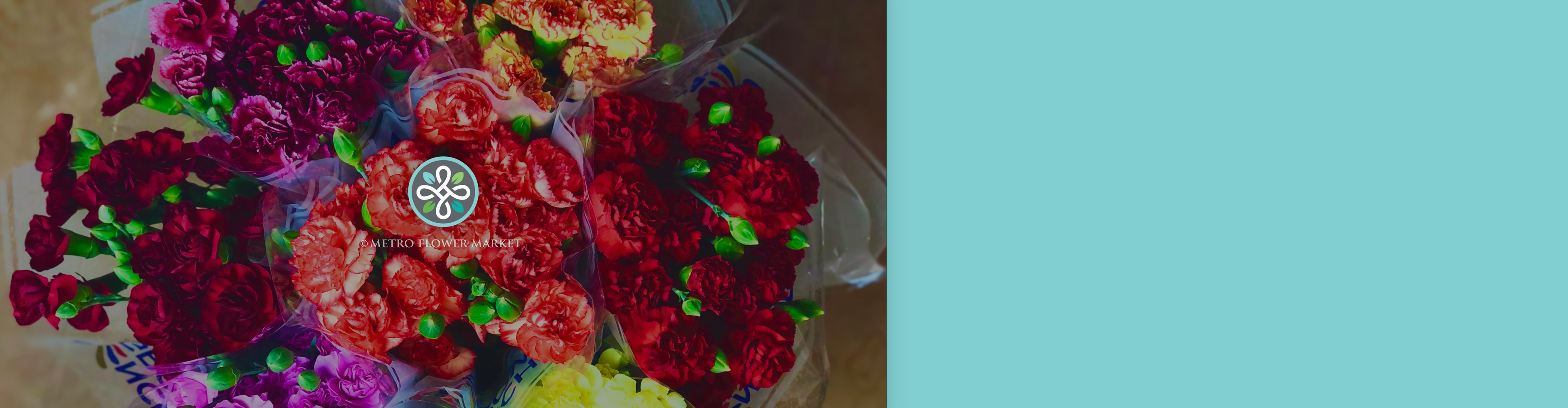 An image of mini carnation bunches sleeved in a bucket for sale on a wooden tabletop. The flowers are burgundy, magenta, bicolor orange and yellow, orange, red, and yellow.